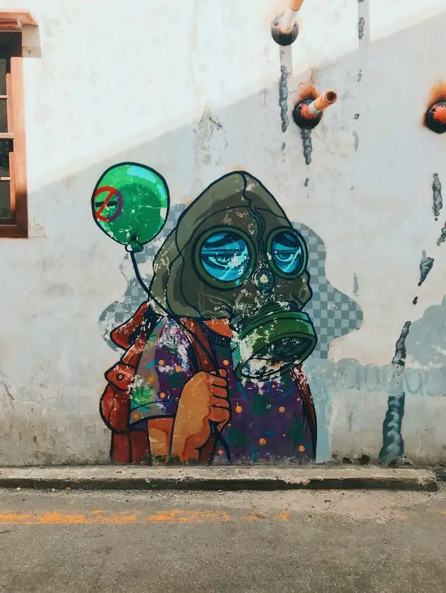 Image of streetart. Kid with a balloon wearing a facemask.