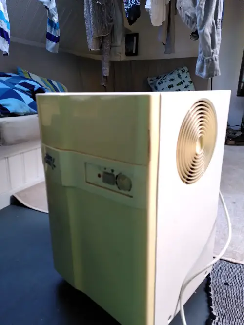 An old model dehumidifier drying laundry